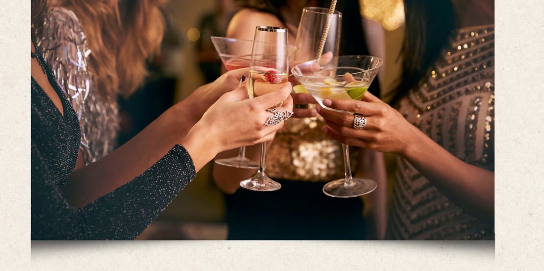 Guests raising cocktail glasses in a private room toast